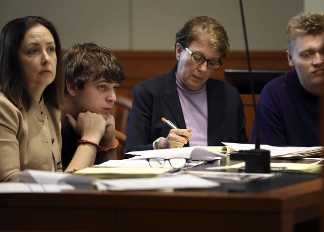 Theodore Eugene Baskette, 20, center, with his attorney, Tina Green, left, listens to witness testimony from officer James Parker during a dangerousness hearing at Brockton District Court on Thursday, March 21, 2019. At right is defendant Domenick Barshaw with his attorney Victoria Bonilla. [Alyssa Stone/The Enterprise]