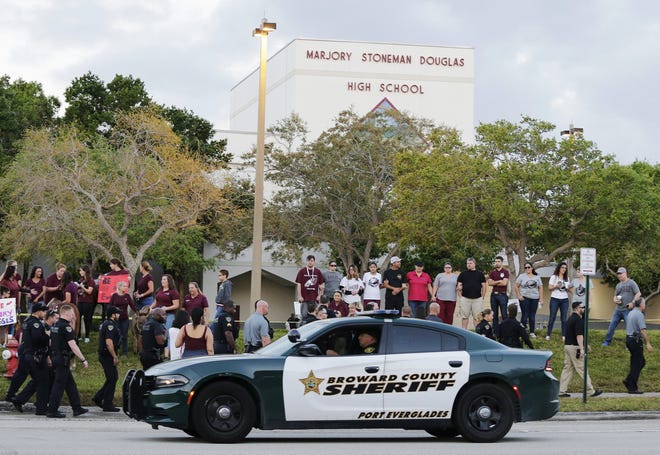 Students return to class at Marjory Stoneman Douglas High School in Parkland on Feb. 28, 2018, two weeks after a former student opened fire with an assault weapon, killing 17. [Terry Renna/The Associated Press]