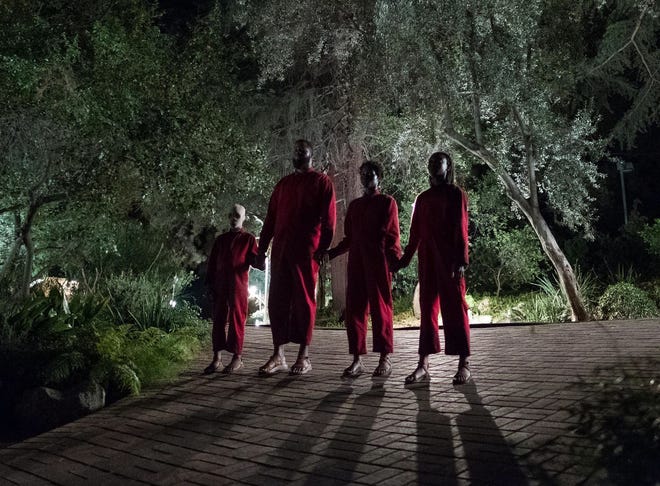 The doppelgangers, from left, Pluto (Evan Alex), Abraham (Winston Duke), Umbrae (Shahadi Wright Joseph) and Red (Lupita Nyong'o) pay a visit to the Wilson family in Jordan Peele's "Us." [Universal Pictures]