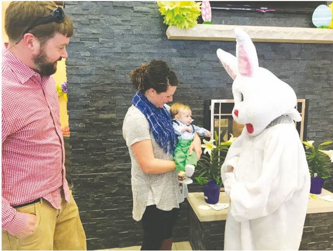 Awestruck Theo Leonard and parents Everett and Jacie say hello to the Easter Bunny during last year's "Bunny Breakfast" at Libby's Cafe inside Fernelius Toyota Chrysler Dodge Jeep Ram.