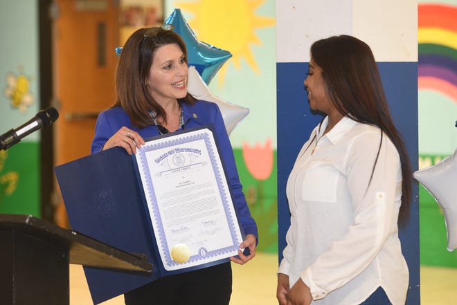 State Rep. Bronna Kahle presents Ary Sanders with a proclamation for her distinction as the Boys and Girls Club of Lenawee Youth of the Year on Thursday during the club’s annual breakfast.