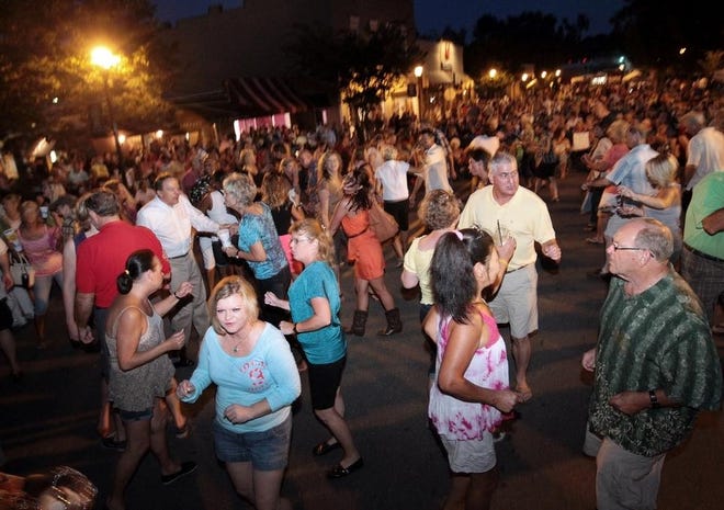 Crowds of people dance and socialize along Main Street during a previous installment of Belmont's Friday Night Live summer concert series. [Gazette file photo]