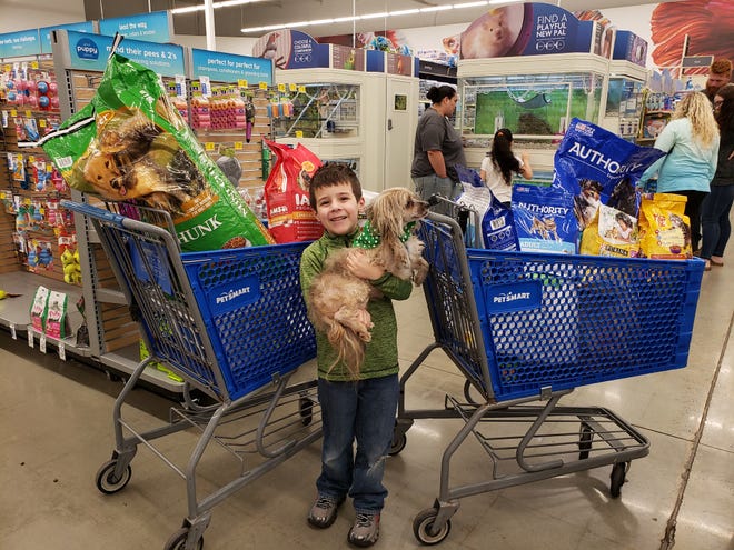 Turner Kuykendall and friend with items donated to Tri-County Animal Rescue in celebration of his sixth birthday. [SUBMITTED PHOTO]