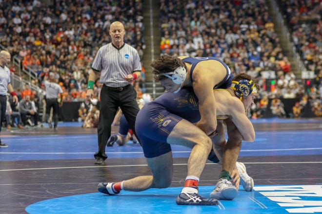 Kent State's Andrew McNally, left, wrestles against Penn State's Shakur Rasheed during the consolation second round at the NCAA Wrestling Championships in Pittsburgh on Friday. (Special to GateHouse Ohio Media / Jim Thrall)