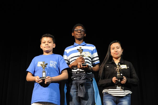 Pictured left to right is second-place winner Grant Haze, first-place winner Ozioma Obi, and third-place winner Daisy Morales Bravo, topped out the competition at the 27th –annual Downeast Regional Spelling Bee held Saturday at the Turnage Theatre in downtown Washington.