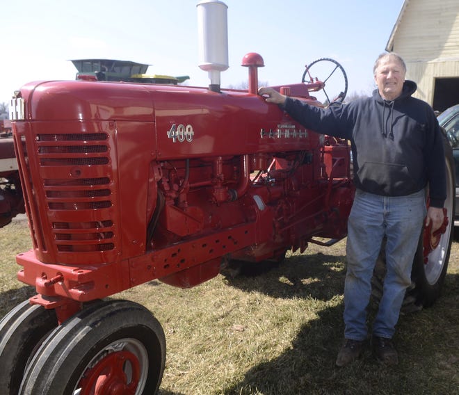Steve Straight, standing with his favorite tractor, was recently named vice president of the International Harvester Club of Belona. He is retiring from full-time farming with his equipment scheduled to be auctioned off Saturday.

[Jack Haley/Messenger Post Media]