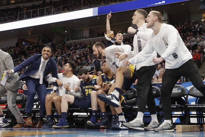 UC Irvine players and coaches celebrate during the second half of a first round men's college basketball game against Kansas State in the NCAA Tournament on Friday in San Jose, Calif. [AP PHOTO/CHRIS CARLSON]