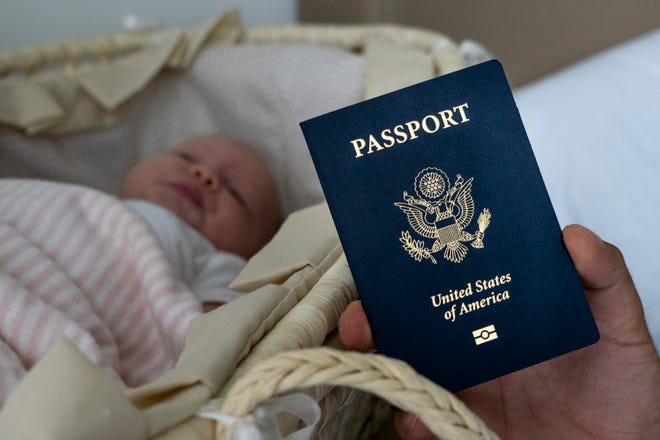 In this photo taken on Jan. 24, 2019, Denis Wolok, the father of 1-month-old Eva's father, shows the child's U.S. passport during an interview with The Associated Press in Hollywood, Fla. Every year, hundreds of pregnant Russian women, like Wolok's wife, Olga Zemlyanaya, travel to the United States to give birth so that their child can acquire all the privileges of American citizenship. (AP Photo/Iuliia Stashevska)
