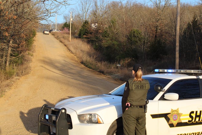 Sheriff's deputy Michelle Cordray blocks off the 46400 block of East 1100 Road near Sallisaw on Friday, March 22, 2019, as authorities investigate a fatal shooting at a residence just off the road. [MAX BRYAN/TIMES RECORD]