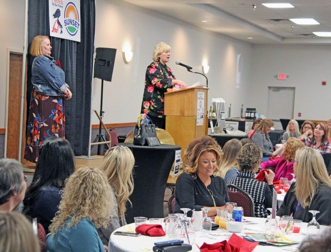 Jan Storrs accepts her award as Woman of the Year in Service during the annual Power of the Purse luncheon at the Dearth Community Center in Coldwater Friday.