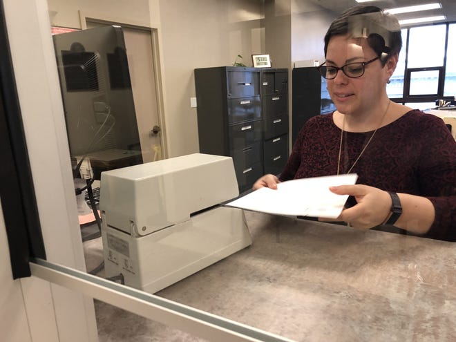 Assistant City Clerk Inez Leite certifies the results of Fall River's recall election Friday, March 22, at Government Center. [Herald News photo by Amanda Burke]
