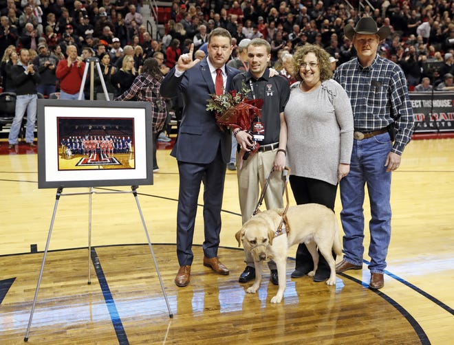 Texas Tech coach Chris Beard poses with Colin Baxter and his family during a senior night presentation before an NCAA college basketball game against Texas, Monday, March 4, 2019, in Lubbock, Texas. [Brad Tollefson/A-J Media]