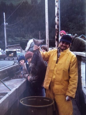Fishing captain Eric Peter Jacobsenholds up a fish when he first arrived in Alaska. (Karen Jacobsen photo)