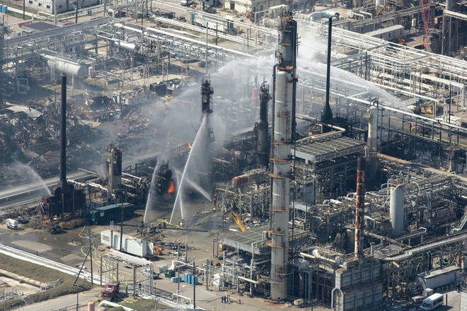 Firefighters pour water on a smoldering unit following an explosion that killed 15 people and injured more than 170 at the BP refinery March 23, 2005, in Texas City, Texas. [Brett Coomer/Houston Chronicle]