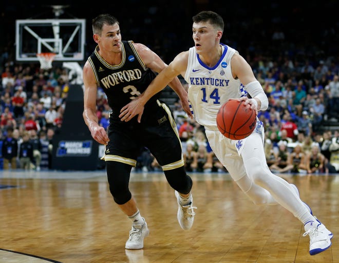 Kentucky's Tyler Herro (14) drives past Wofford's Fletcher Magee during the second half of Saturday's NCAA Tournament second-round game in Jacksonville. [Stephen B. Morton/The Associated Press]