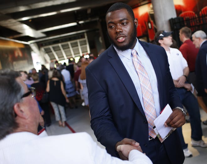 Georgia offensive lineman Andrew Thomas shakes hands with supporters during the dedication ceremony for the new West End Zone at Sanford Stadium on Aug. 31, 2018 in Athens. [JOSHUA L. JONES/ATHENS BANNER-HERALD]