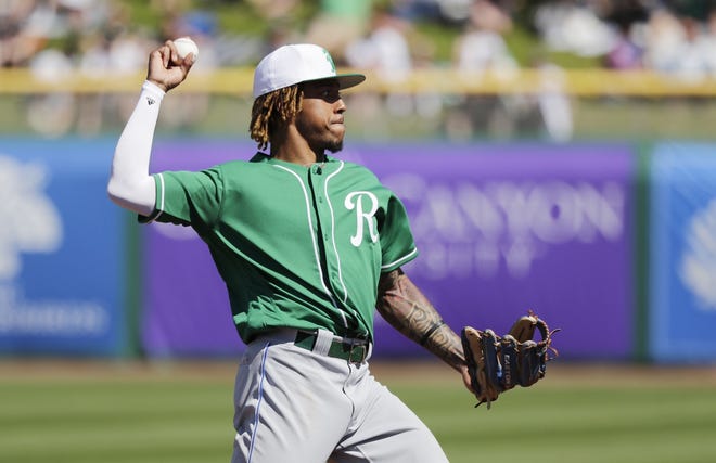 Kansas City Royals shortstop Adalberto Mondesi makes a throw against the San Francisco Giants in a spring training game on St. Patrick's Day in Scottsdale, Ariz. [Elaine Thompson/The Associated Press]