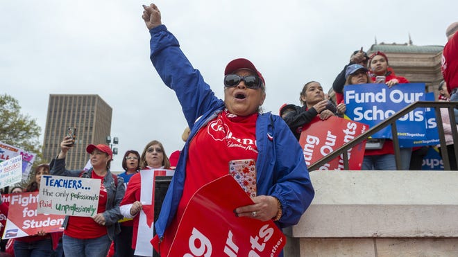 Koni Kaiwi, of Garland, cheers for teacher pay raises during a Capitol rally in March. [STEPHEN SPILLMAN/FOR STATESMAN]