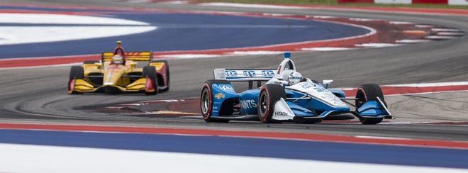 Driver Josef Newgarden (2) of United States is chased by Ryan Hunter-Reay (28) of United States during Sunday's IndyCar Classic auto race at Circuit of the Americas. [Stephen Spillman/For Statesman]