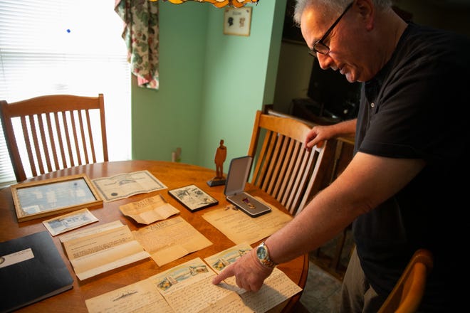 Leonard Gabriele, of Falls, looks over letters written by his uncle while he was stationed in Pearl Harbor with the Navy. [DAVE HERNANDEZ/CORRESPONDENT]