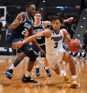 Purdue's Carsen Edwards, right, dribbles around Villanova's Dhamir Cosby-Roundtree, left and Villanova's Collin Gillespie, back, during the second half of the NCAA tournament's second round on Saturday in Hartford, Conn. [JESSICA HILLS / THE ASSOCIATED PRESS]