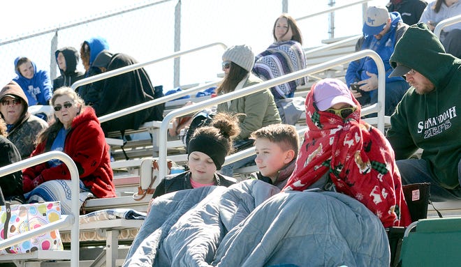 Saturday started out pretty chilly for the crowd at Meadowbrook High School’s track meet. Many brought warm coats, hats and blankets to keep warm in the stands at the track and field meet.