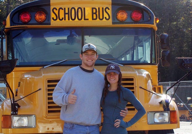 Jack Labosky, left, and Madi Hiatt pose after purchasing a school bus Oct. 30, 2018 in Lynchburg, Va. Labosky is a minor league pitcher in the Tampa Bay Rays organization, and he and Hiatt, his girlfriend, plan to live out of the bus. [Madi Hiatt via AP]