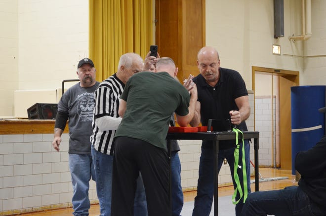 Larry Osterbird (right) competes in the arm wrestling competition on Saturday, March 23 at Prince George Wellness Center [Lindsey Lanham/progress-index.com]