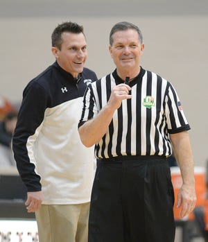 Referee Carl Davidson listens to Carrollton head coach Mike Aukerman as he works the Warriors game against New Lexington during the Mercy Medical Classic at Hoover High School on Feb. 17.  (CantonRep.com / Ray Stewart)