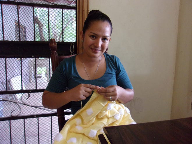 A Nicaraguan woman who is part of the Jacobys' knitting business at work on one of their SheepDreamzzz blankets. The couple employs about 20 women who take 100 percent of the profit as personal income. [CONTRIBUTED]