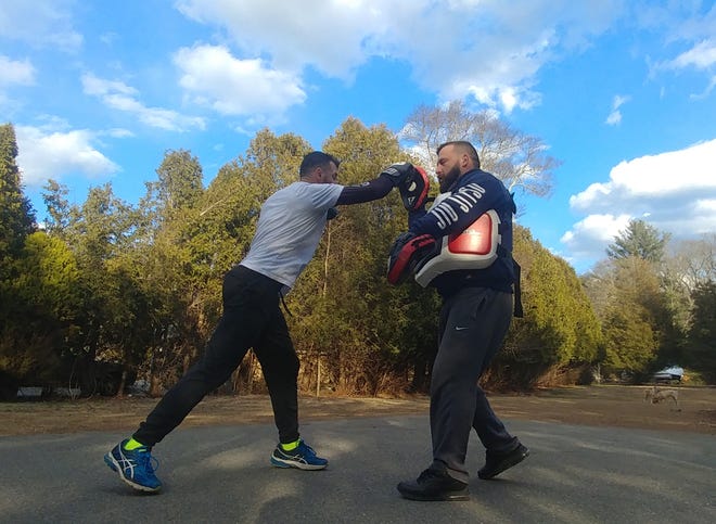 42-year-old Jim Manning of Marion trains with his sparring coach, Tyler Pimental of Dartmouth, while preparing for his professional MMA comeback on April 6 during Cage Titans 43 in Plymouth. [BRENDAN KURIE/STANDARD-TIMES SPECIAL/SCMG]