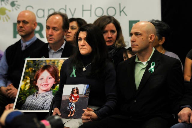 Jeremy Richman, right, during a press conference on Jan. 14, 2013, beside his wife Jennifer Hensel, center, holding a photo of their daughter Avielle, who was killed in the Dec. 14, 2012, Sandy Hook Elementary School shooting. Jeremy Richman was found dead early Monday at Edmond Town Hall in Newtown, Conn., police said. (Richard Messina/Hartford Courant/TNS)