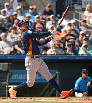 FILE - In this Thursday, March 7, 2019, file photo, Houston Astros' Carlos Correa follows through on a foul ball during the third inning of a spring training baseball game against the Miami Marlins at the Roger Dean Chevrolet Stadium on in Jupiter, Fla.(David Santiago/Miami Herald via AP, File)