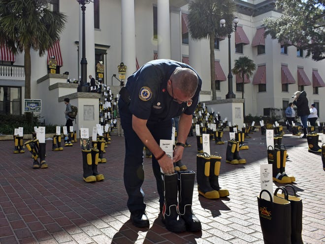 Palm Coast Fire Lt. Richard Cline, a cancer survivor, places his boots on the steps of the State Capitol recently to raise awareness for firefighter occupational cancer. Cline was diagnosed with thyroid cancer in 2014. In all, 500 pairs of firefighter boots lined the steps to raise awareness of firefighter occupational cancer. [Photos provided/City of Palm Coast]