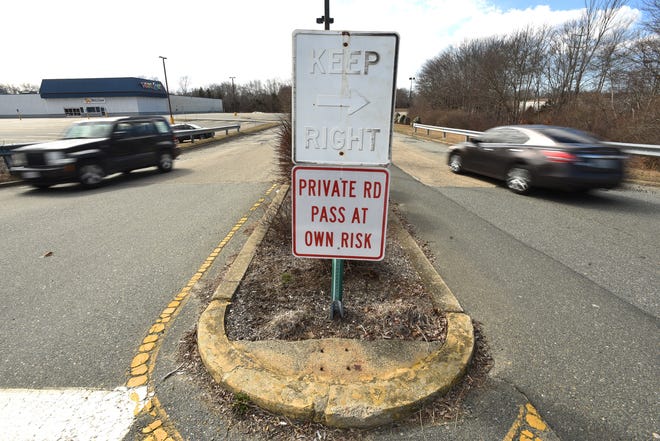 A new sign joins an old one on a road, off Swansea Mall Drive, leading to the Swansea Mall property, and also to Walmart, seen Monday, March 25, 2019, in Swansea, Massachusetts. [Herald News Photo | Jack Foley]