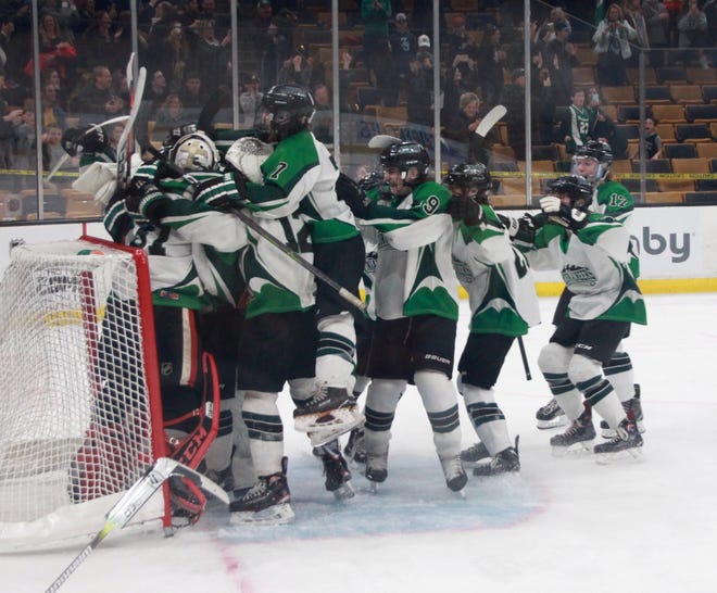 Players celebrate their state championship win on March 17 at TD Garden. [JOYCE ROBERTS PHOTO]