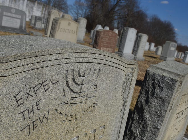 Anti-Semitic graffiti mars a memorial stone at the Jewish cemetery on McMahon Street, seen Monday, March 18, in Fall River. [Herald News Photo | Jack Foley]