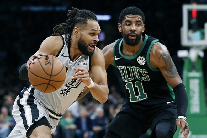 San Antonio's Patty Mills drives past Boston's Kyrie Irving during the second half of Sunday's game in Boston. Irving will be rested when the Celtics play in Cleveland on Tuesday night. [AP / Michael Dwyer]