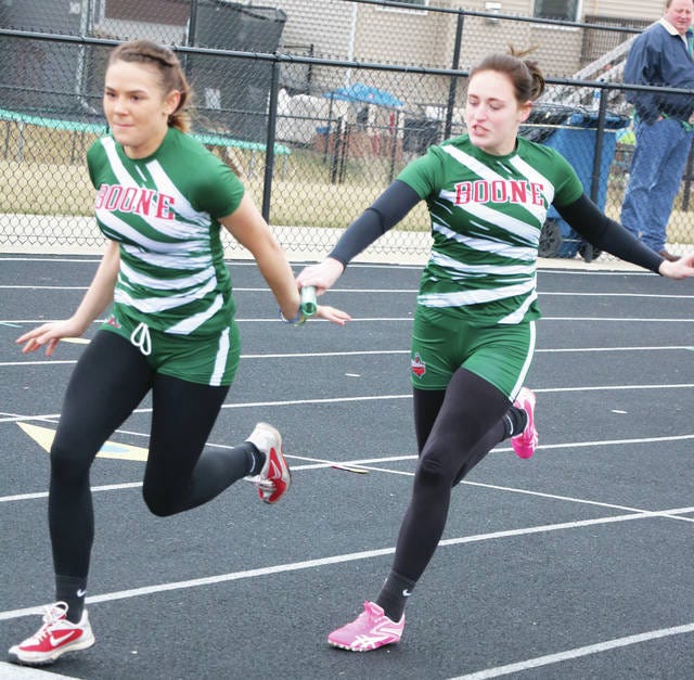 Bailey Price hands off to Polina Trouch during Monday’s track meet at Bondurant-Farrar. Price and Trouch were part of a sprint-medley relay, along with Zoey Hightshoe and Maggy Muller, that placed third in a time of 2:06.61. Photo by Andrew Logue/News-Republican