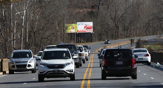 Vehicles drive across the Wilkinson Boulevard/U.S. 74 bridge over the Catawba River in this December 2017 file photo. The N.C. Department of Transportation is holding a public meeting from 4-7 p.m. April 4 at McAdenville Wesleyan Church on Wesleyan Drive to share more information about the proposed widening of the road and replacement of the aging bridge. [Mike Hensdill/The Gaston Gazette]