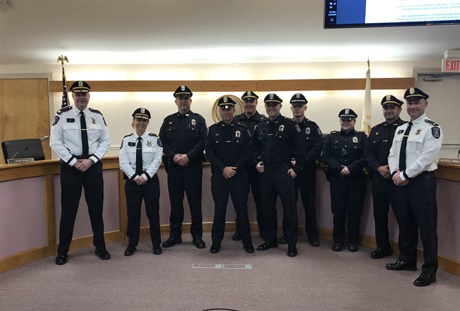 Major Maryanne D. Perry, second from left and second in command at the Portsmouth Police Dpeartment, posed with members of the department Monday night at Town Hall after a proclamation was read in her honor. Perry, the town's first female deputy chief, will retire in April. [JANINE WEISMAN/DAILY NEWS PHOTO]