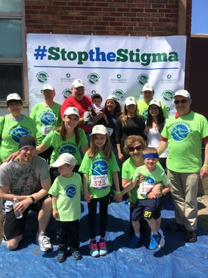 A group from First Congregational Church of Braintree poses for a photo before the 2018 Stop the Stigma 5K. The race supports those affected by mental illness and addiction. (Hurley Event Photography)