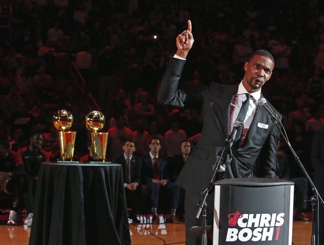 Former Miami Heat player Chris Bosh addresses the crowd during Tuesday's ceremony to retire his number at halftime of Miami's game against the Orlando Magic. [DAVID SANTIAGO/Miami Herald]