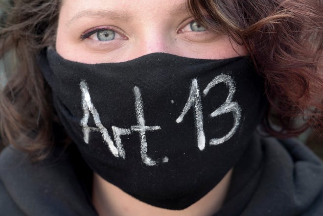 A girl protests against article 13, concerning upload filters, of the Directive on Copyright in the Digital Single Market by the European Union in Leipzig, Germany, Saturday, March 23, 2019. People fear for the freedom of the internet when users content has to pass upload filters to protect copyrights. (Peter Endig/dpa via AP)
