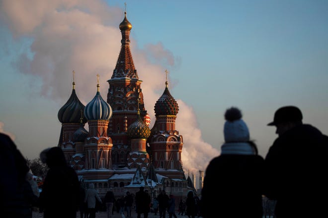FILE - In this Thursday, Jan. 24, 2019 file photo, people walk in Red Square on a cold day, with St. Basil's Cathedral in the background, in Moscow, Russia. A senior Russian lawmaker on Monday March 25, 2019, has welcomed the findings of special counsel Robert Mueller's report on Russian involvement in the U.S. presidential election, saying this gives the countries a chance to mend ties. (AP Photo/Pavel Golovkin, File)