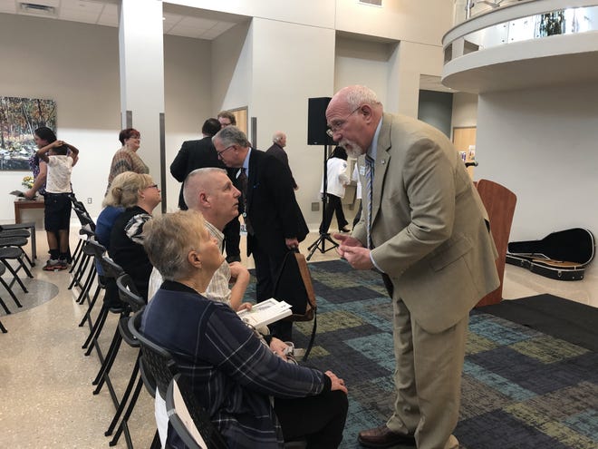 Kyle Parker, right, president and CEO of the Arkansas Colleges of Health Education, speaks with Teddy Havins, the husband of an anatomical donor, on Monday, March 25, 2019, at the Arkansas College of Osteopathic Medicine memorial service for donor families. Havins' wife gave her body to the medical college for students to study. [JADYN WATSON-FISHER/TIMES RECORD]