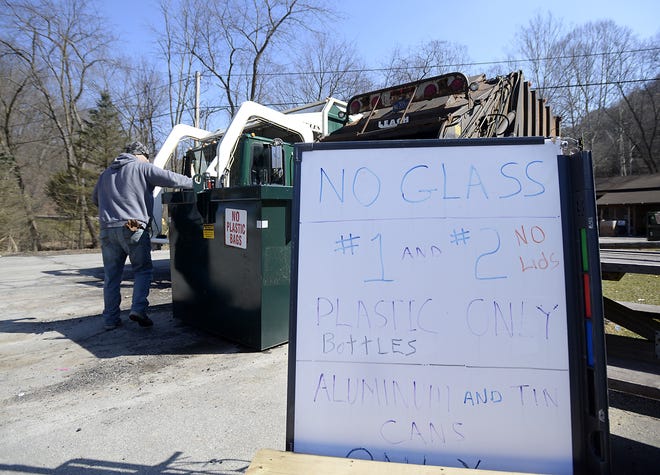 A worker at the Beaver County Recycling Center sorts through a dumpster full of plastics and aluminum while picking out nonrecyclables recently at Bradys Run Park in Brighton Township. Glass is no longer being accepted at the center. [Sally Maxson/for ECL]
