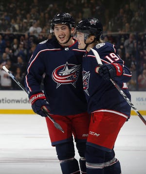 The Blue Jackets' Zach Werenski, left, celebrates with Ryan Dzingel after Dzingel scored during a 4-0 victory over the New York Islanders on Tuesday. The Jackets are hoping for a similar effort — and result — on Thursday against the Canadiens, whom they currently are battling for the final playoff spot in the East. [Adam Cairns/Dispatch]
