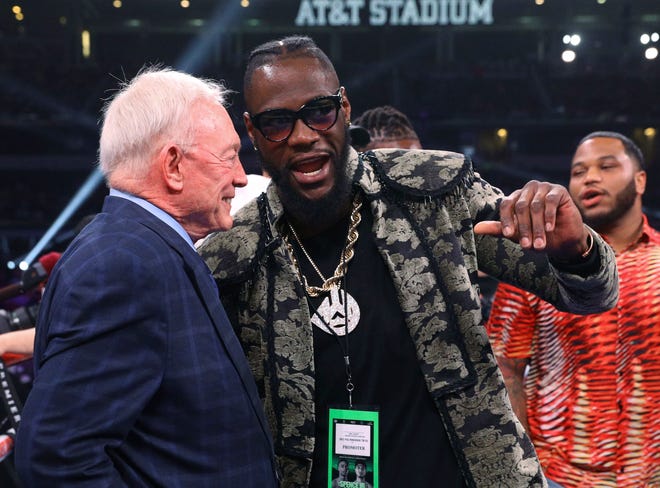 Dallas Cowboys owner Jerry Jones talks with boxer Deontay Wilder before the IBF welterweight championship boxing bout between Errol Spence Jr. and Mikey Garcia on Saturday, March 16, 2019, in Arlington, Texas. (AP Photo/Richard W. Rodriguez)