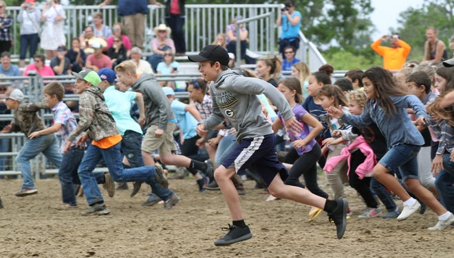 Kids race to catch chickens during last year's Flagler County Cracker Day. This year's event takes place Saturday at the Flagler County Fairgrounds. [News-Tribune file/Nigel Cook]